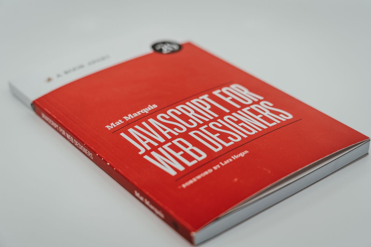 Un libro naranja que dice Javascript para diseñadores web